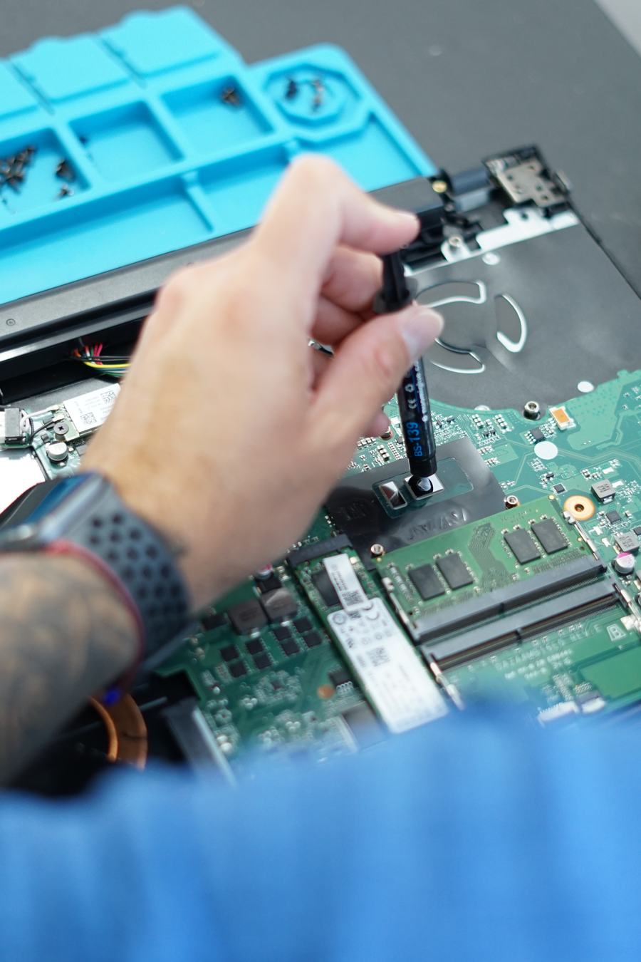 Applying thermal paste during a laptop repair